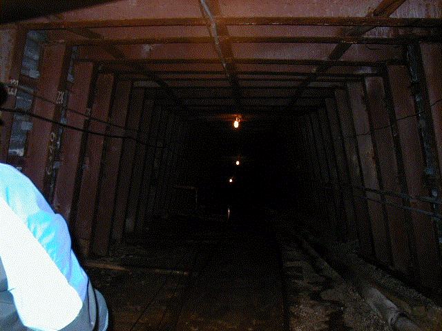 Looking up the slope, through the steel sets that support its roof and walls.