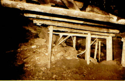 A roof fall, where the timbers have been partly crushed by pressure